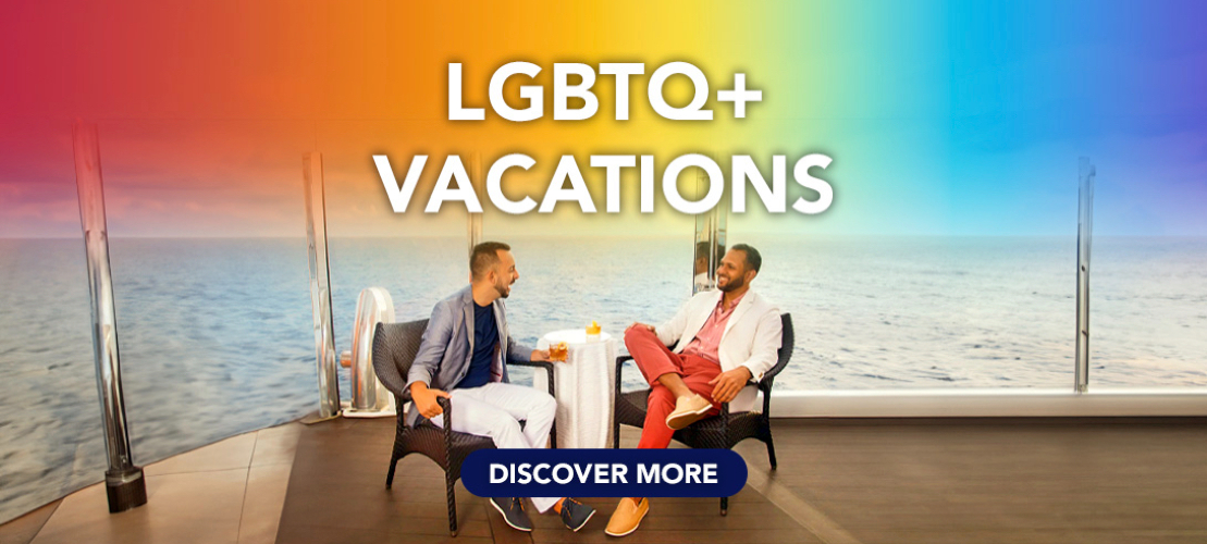 LGBTQ+ Vacations,  2 men enjoying cocktails on a cruise ship with the coean behind them.